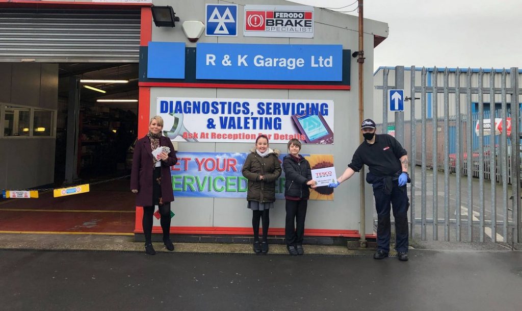 Pupils from local school collection a donation from the garage